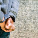Closeup of a juvenile being in handcuffs after getting in legal trouble