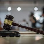 Judge with a gavel overseeing a judicial proceeding.