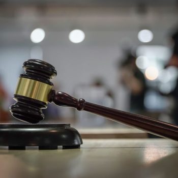 Judge with a gavel overseeing a judicial proceeding.